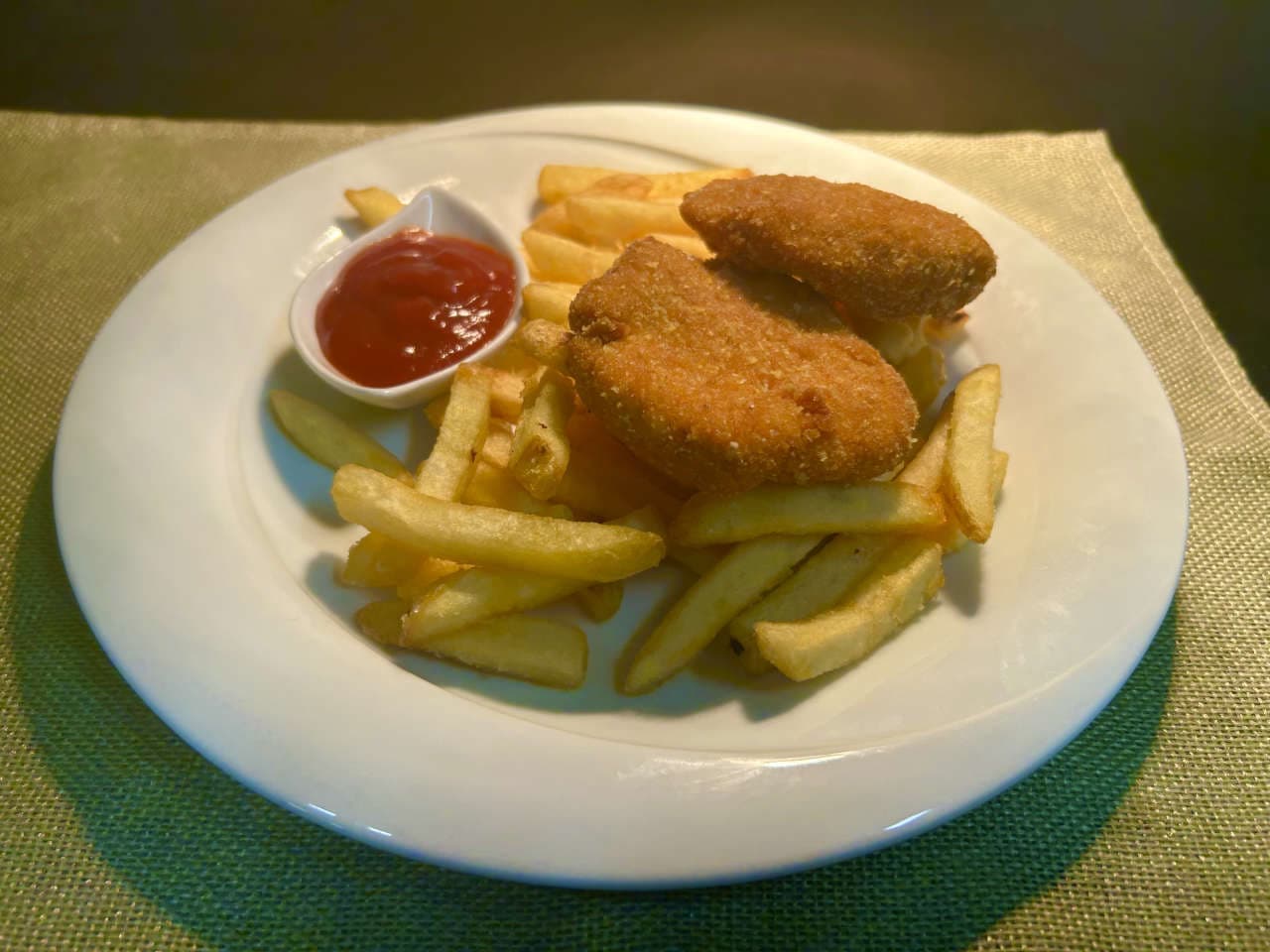 Homemade chicken nuggets, french fries, ketchup